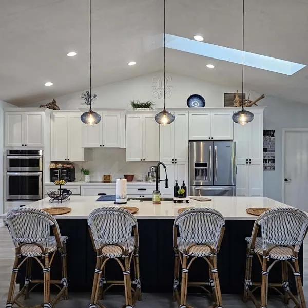 Kitchen with pendant lights over the island and recessed lighting