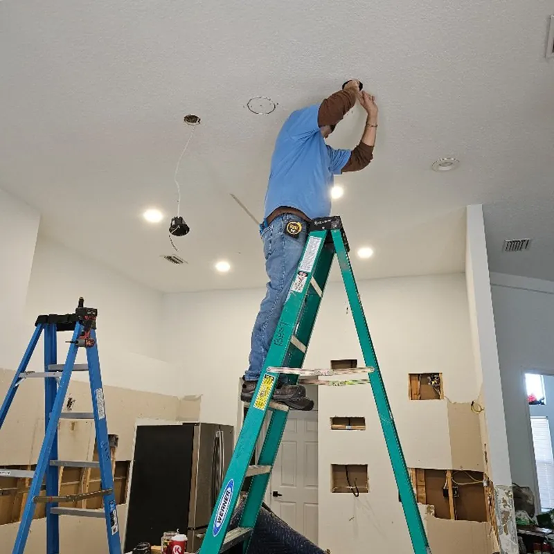 Installing a ceiling light fixture from a ladder